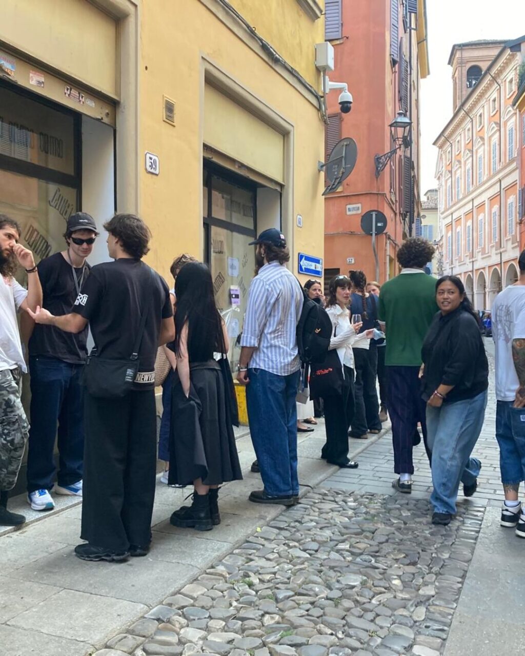 People queuing outside Inchiostrostudio in Modena for the DENTRO Attic exhibition